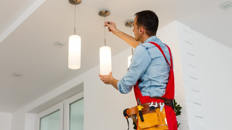 Man fixing and hanging lights 