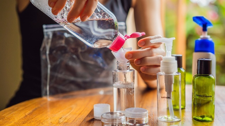 person mixing soap in bottle