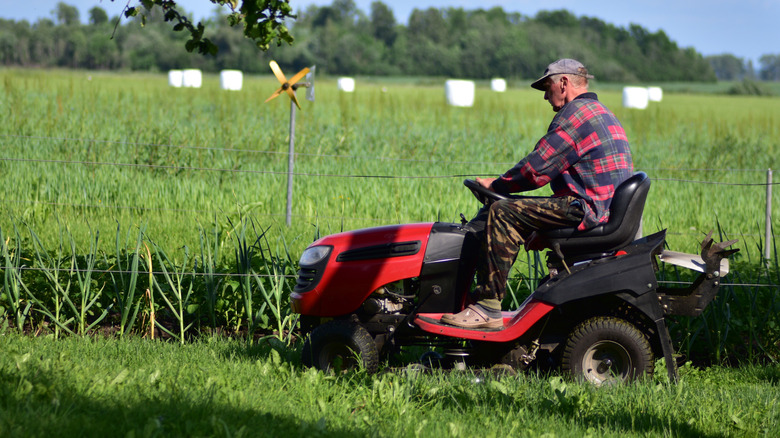 Driver operating a lawn mower