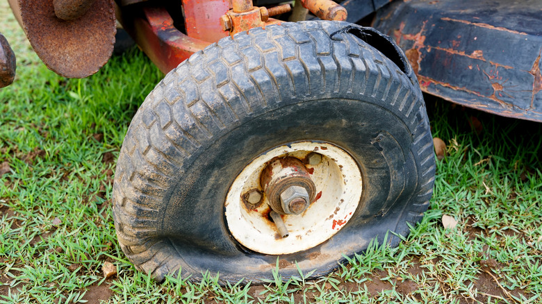 Flat tire on a vintage riding lawn mower
