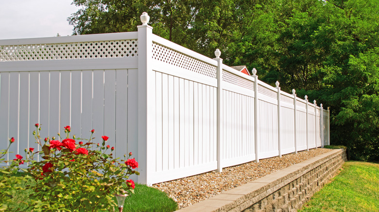 Vinyl fencing installed near a garden bed