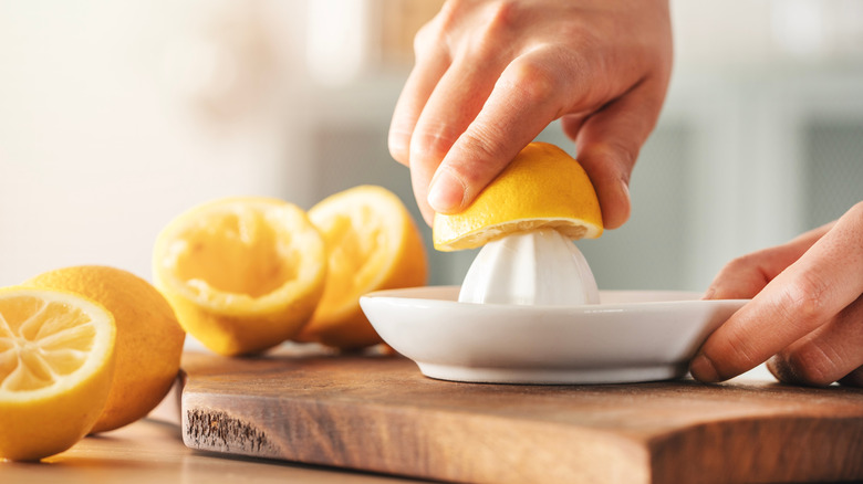 Squeezing lemon juice in the kitchen