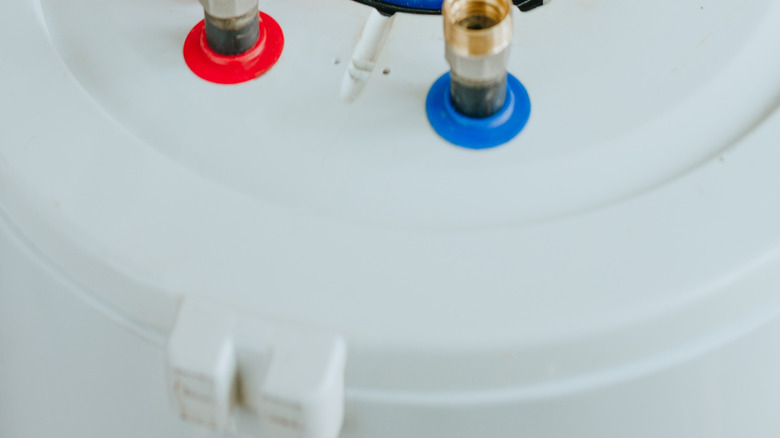 Person working on wiring on a water heater