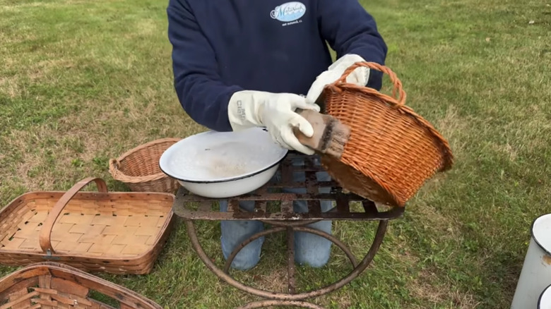 Baskets being cleaned with a scrub brush and soapy water