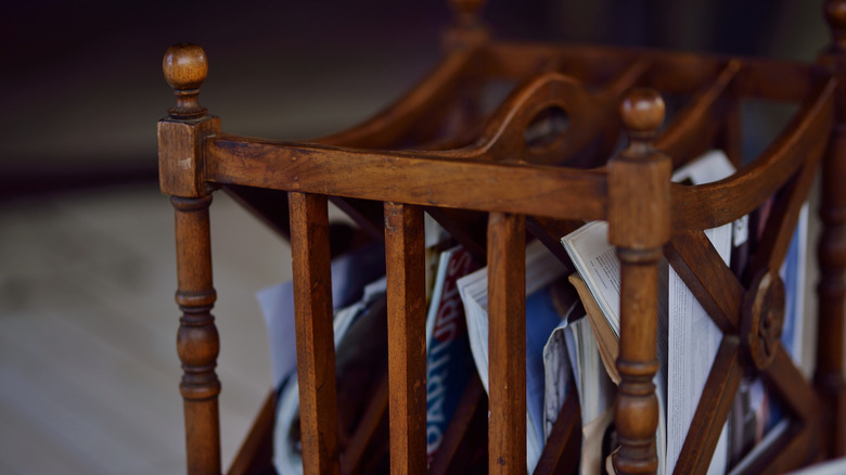 A vintage magazine holder lined with magazines