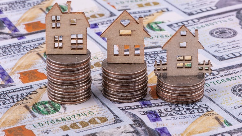 Miniature houses sitting on money