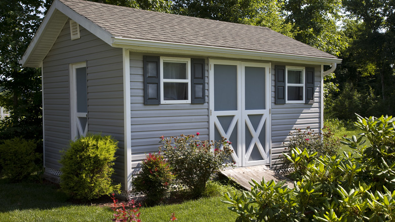 A beautiful shed the size of a small house in a backyard