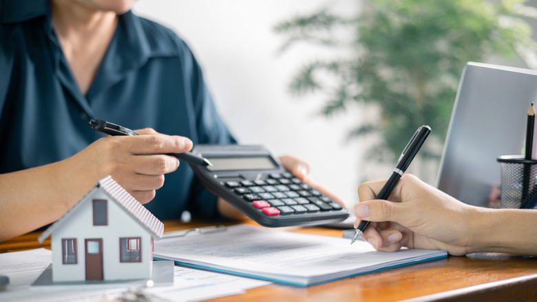 A person calculating mortgage expenses with the help of an accountant