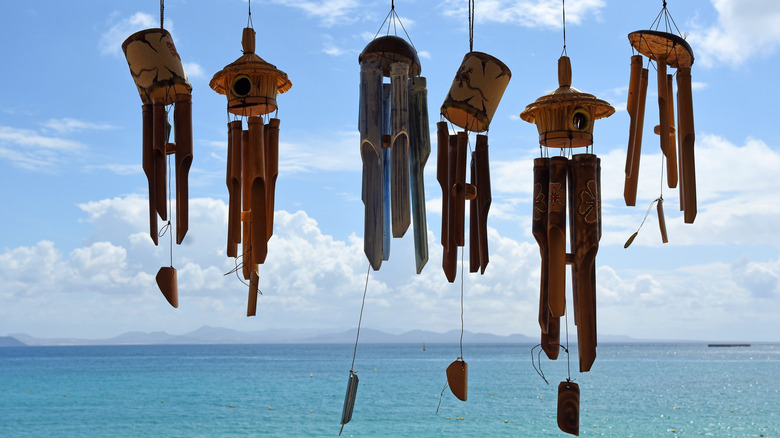 Wind chimes hanging above ocean