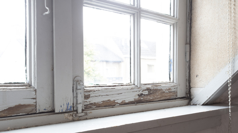 Old windows painted white with gaps