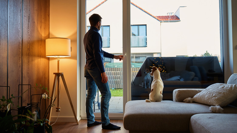 person in apartment with lamp