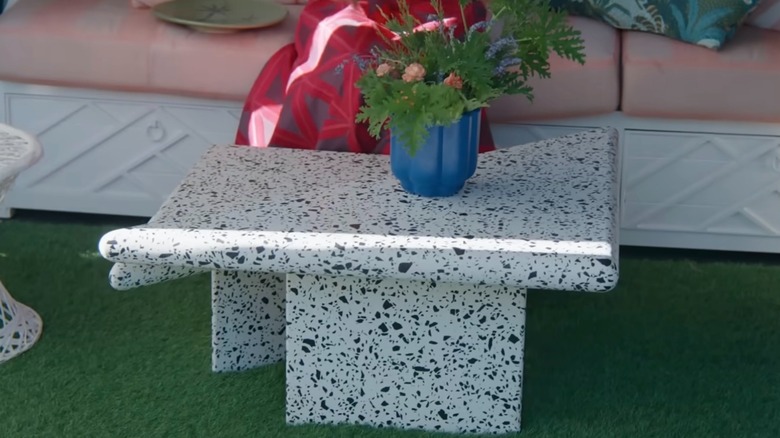 Isabel Ladd's white and black terrazzo coffee table displayed on faux grass.