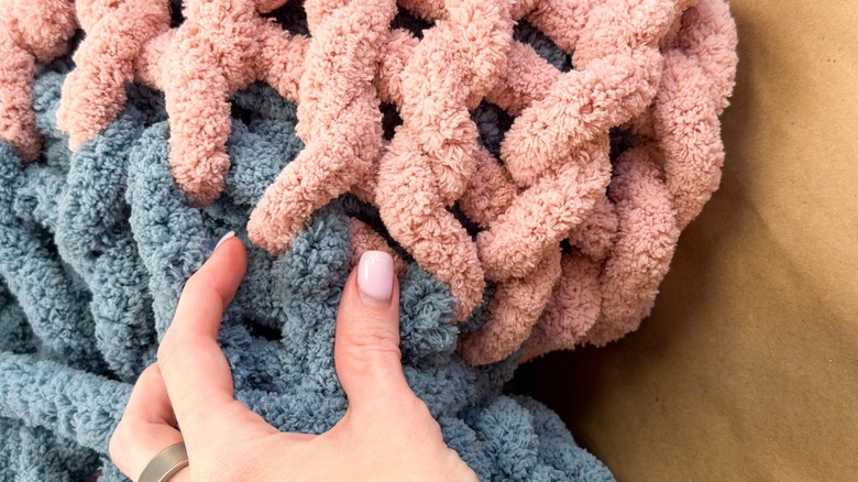 Blue and pink chunky yarn on table