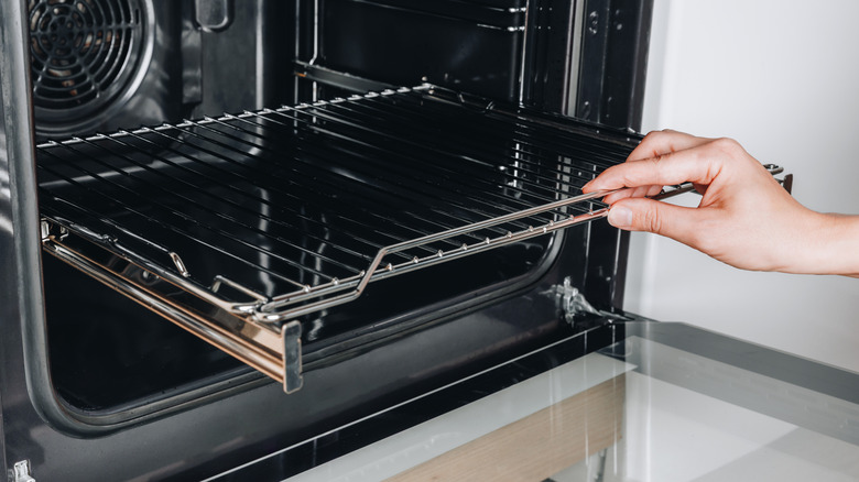 Hand pulling a wire oven rack