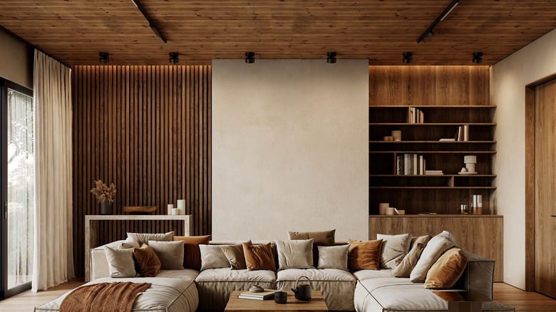 The interior of a contemporary loft features wood slats on accent walls and the ceiling