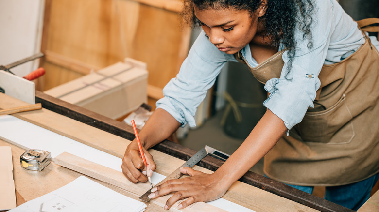 Woman working on a wood DIY