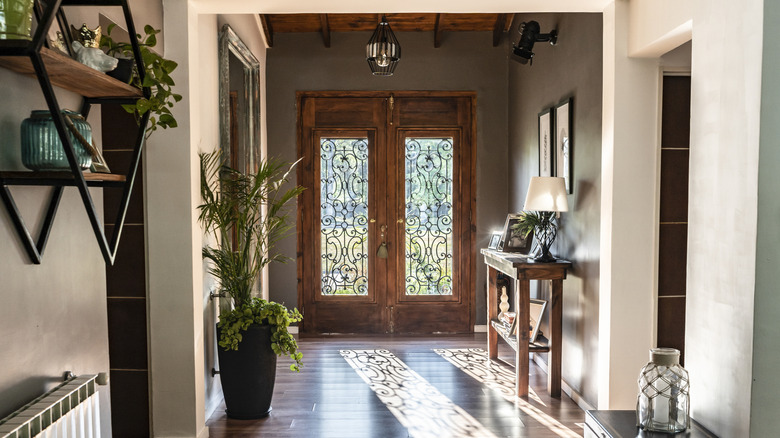 A wooden double front door with glass panes