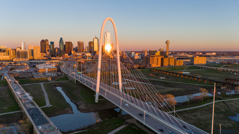 Aerial photo of Dallas, Texas at dusk featuring the skyline and the Margaret Hunt Hill Bridge