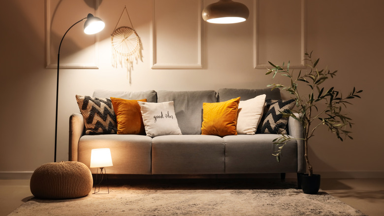 A living room with three different lights over the couch