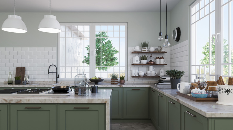 A kitchen with lower cabinets and open shelving for upper storage
