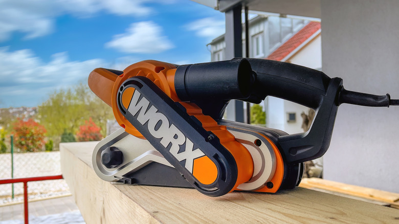 A Worx tool sitting atop a piece of wood