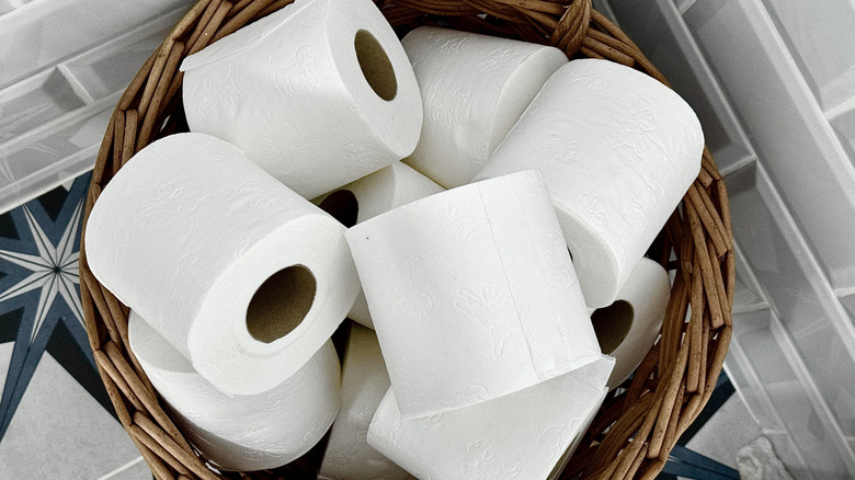 A basket full of toilet paper rolls