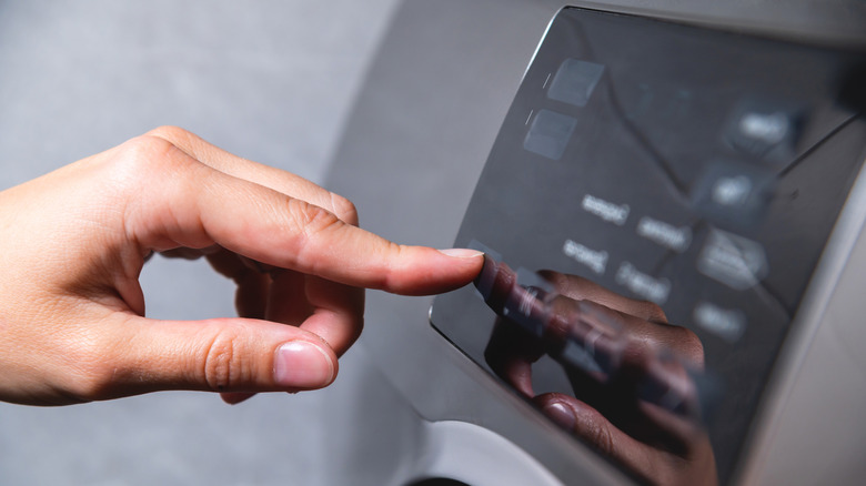 Person setting laundry machine