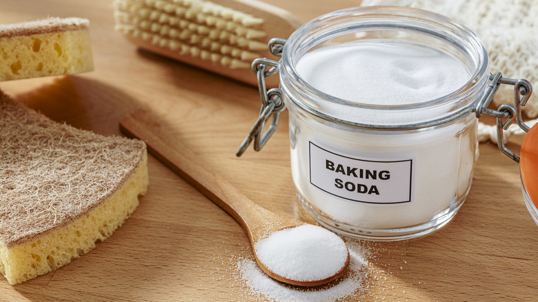 jar of baking soda next to spoon