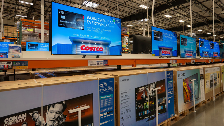 Costco warehouse display of Samsung TVs with boxed products underneath