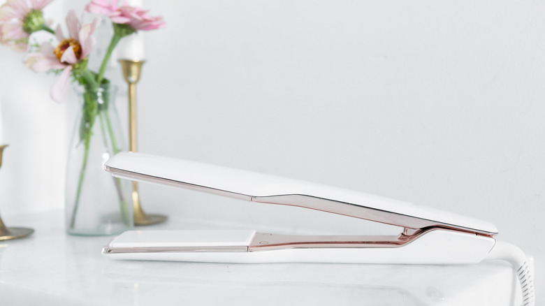 hair straightener with flowers in background