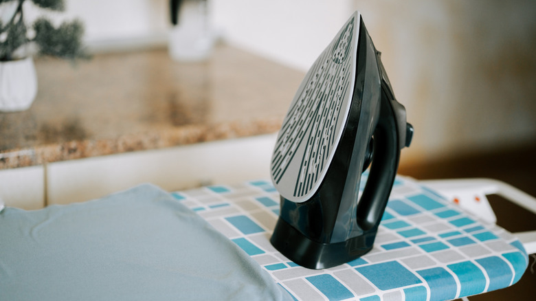 iron sitting on ironing board