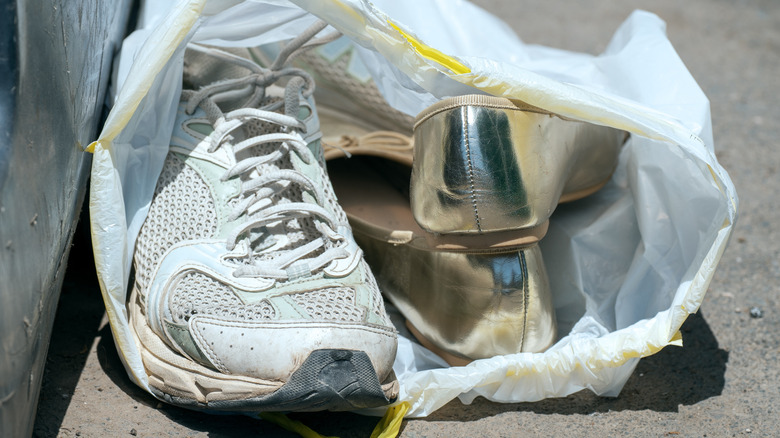 Old shoes in a plastic trash bag