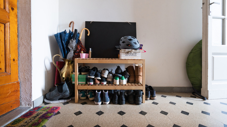 A shoe rack next to the front door