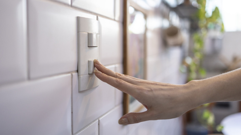 hand flipping light switch