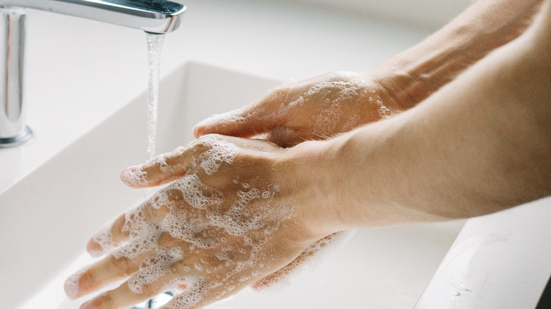 washing hands in sink
