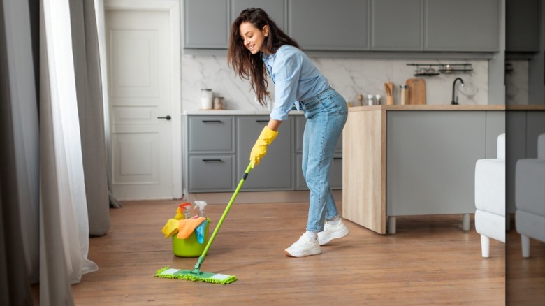 person mopping kitchen floor