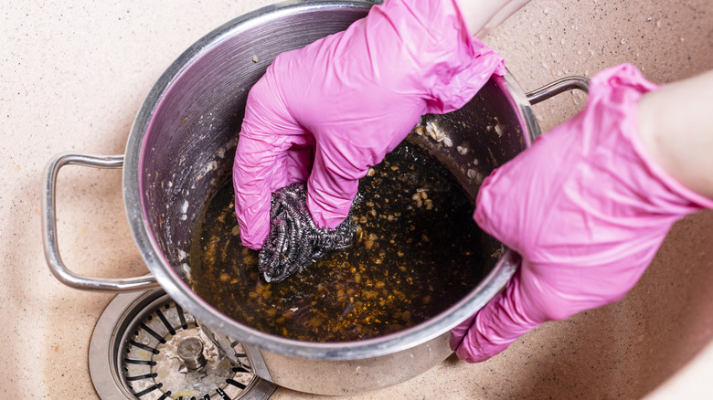 hands scrubbing gross pot