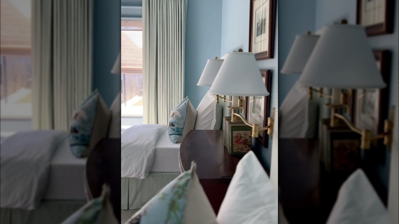 Dark wood dresser with antique books and contemporary bedding in grandmillennial kids bedroom