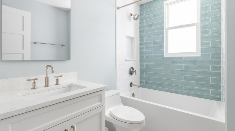 Clean bathroom with vanity, toilet, and shower