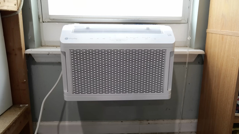 An interior shot of a GE over-the-sill air conditioner installed in a window