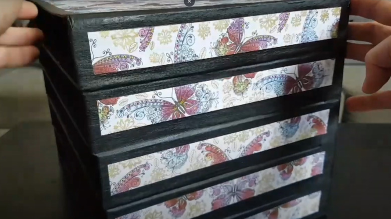 Butterfly-patterned paper file shelving made out of pizza boxes