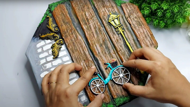 Farmhouse-style sign made of paint, clay, and cardboard