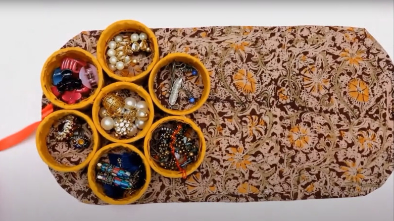 DIY Ornate small storage containers nestled in floral fabric-wrapped pizza box