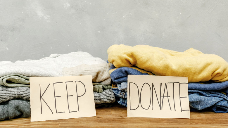 Two piles of clothing. One is labeled KEEP and the other is labeled DONATE.