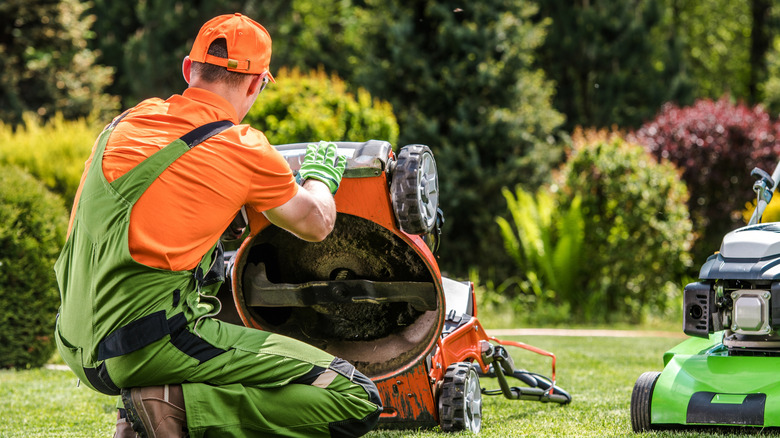 lawn mower technician working on mower