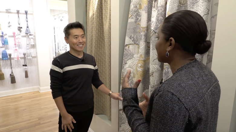 Vern Yip holding a patterned curtain