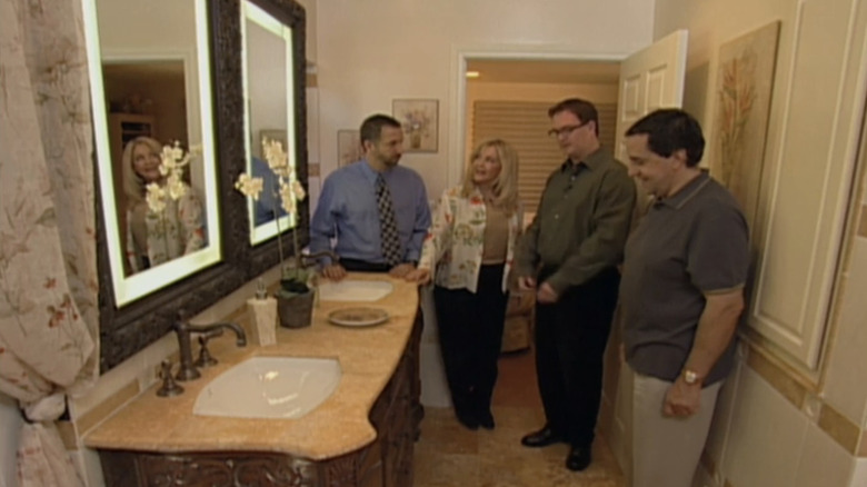 A group of people standing in a 2000s master bathroom
