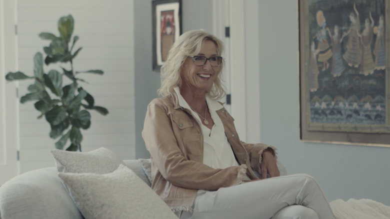 Candice Olsen smiling while sitting on a couch