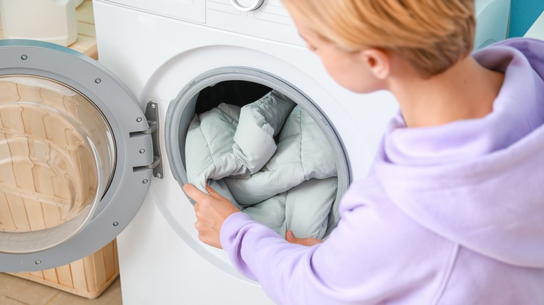 Person removing jacket from washer