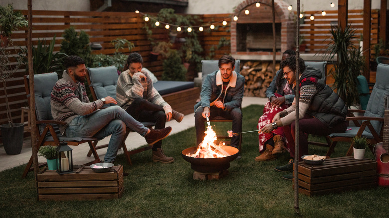 roasting marshmallows around fire pit